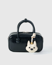 Wear the white Tokyo Shiba charm on a bag with the leather strap loop, or clip it to keys with the 18K gold-plated keychain clip.