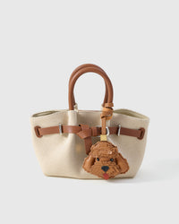 Poodle leather bag charm shown in both attachment options — handmade French Alran goatskin, dual attachment for bags or keys. STICKYZOO Amsterdam design.
