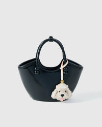 Handmade Poodle leather bag charm styled on a handbag — French Alran goatskin, 18K gold-plated hardware. STICKYZOO Amsterdam design.