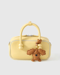 Poodle leather bag charm shown in both attachment options — handmade French Alran goatskin, dual attachment for bags or keys. STICKYZOO Amsterdam design.