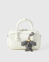 Poodle leather bag charm shown in both attachment options — handmade French Alran goatskin, dual attachment for bags or keys. STICKYZOO Amsterdam design.