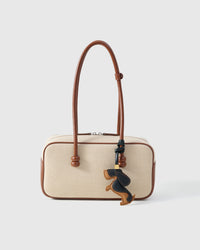 Every panel of the dachshund charm is cut by hand and stitched through real French leather. Layered slowly for depth — no prints, no stamps.