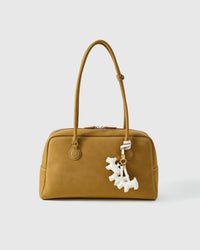 Every panel of the triple schnauzer charm is cut by hand and stitched through real French leather. Layered slowly for depth — no prints, no stamps.