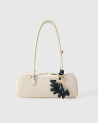 Every panel of the triple schnauzer charm is cut by hand and stitched through real French leather. Layered slowly for depth — no prints, no stamps.