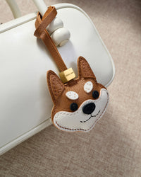 Every panel of the orange Tokyo Shiba charm is cut by hand and stitched through real French leather. Layered slowly for depth — no prints, no stamps.
