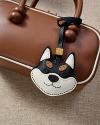 Every panel of the black-and-orange Tokyo Shiba charm is cut by hand and stitched through real French leather. Layered slowly for depth — no prints, no stamps.