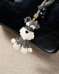 Every panel of the gray urban schnauzer charm is cut by hand and stitched through real French leather. Layered slowly for depth — no prints, no stamps.