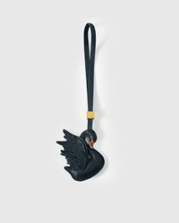 Handmade leather swan bag charm by STICKYZOO — French Alran goatskin hand-layered and hand-stitched by one artisan over 3 days. Handmade leather strap with engraved 18K gold-plated cube. Designed in Amsterdam.