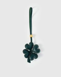 STICKYZOO Lucky Clover Charm in forest-green French Alran goatskin — four padded heart-shaped petals with contrast cream stitching, gold-plated hardware. 3-day handmade piece.