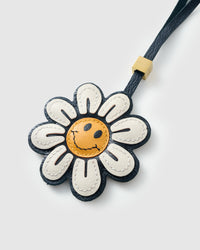 STICKYZOO Smile Flower Charm — hand-layered French Alran goatskin, daisy petals with smiley face centre. Designed in Amsterdam.