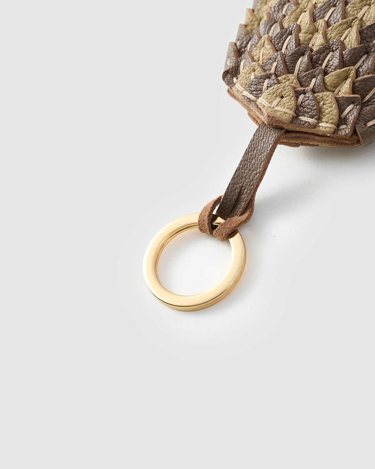 Scaled charm — five days of hand-work per piece. Built slow.