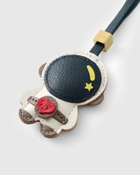 ASTRONAUT CHARM on an 18K gold-plated keychain clip with engraved STICKYZOO disc — clips to keys, bags or backpacks.