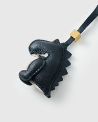 Black dinosaur charm on a bag, side angle — 5,000+ reviews across STICKYZOO. Real French leather, 3 days by hand.