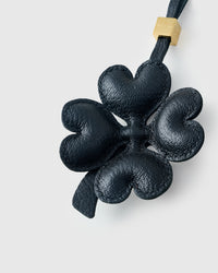Close-up of STICKYZOO Lucky Clover Charm — full-grain French Alran goatskin from Tarn, France. Padded heart-shaped petals. 3-day handmade piece.