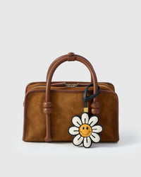 STICKYZOO Smile Flower Charm — hand-cut, hand-stitched daisy petals with smiley face centre in French Alran goatskin. Designed in Amsterdam.