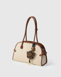 Scaled charm — finished one at a time, by hand.