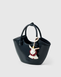 RABBIT CHARM charm styled on a bag — a small, specific piece that turns a simple bag into a personal one.
