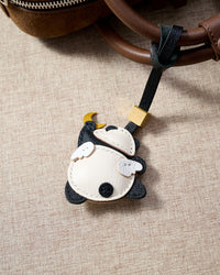 MOON PANDA CHARM charm styled on a bag — a small, specific piece that turns a simple bag into a personal one.