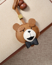 TEDDY BEAR CHARM charm styled on a bag — a small, specific piece that turns a simple bag into a personal one.