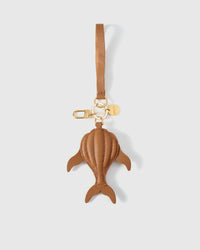 Caramel whale charm — dimensional puffed body, not flat. Real French Alran goatskin, stitched by hand.