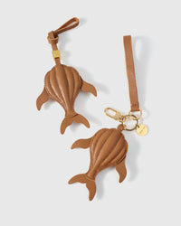 Caramel whale on an 18K gold-plated keychain clip with engraved STICKYZOO disc — clips to keys, bags or backpacks.