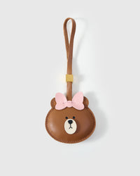 CUDDLY BEAR CHARM charm handmade from French Alran genuine goatskin — A bear with a pink bow. The face is warm caramel, the. Three days by hand. Arrives in luxury gift packaging. Designed in Amsterdam.