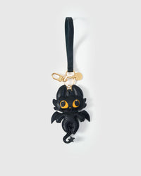 Both editions of the black dragon — leather strap loop for bags, or 18K gold-plated keychain clip.