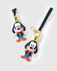 Both editions of the Goofy charm — leather strap loop for bags, or 18K gold-plated keychain clip.
