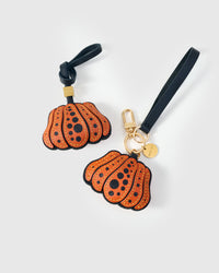 Wear it on a bag with the leather strap loop, or clip it to keys with the 18K gold-plated keychain clip. Two ways to carry one piece.