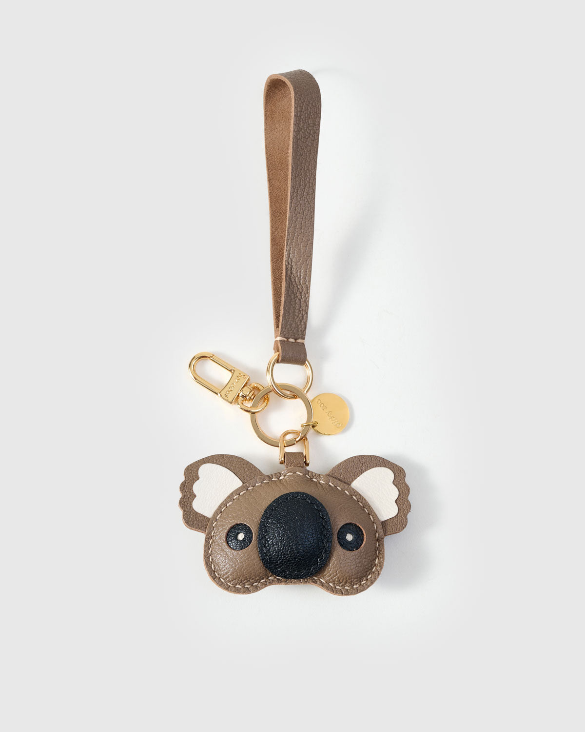 Both editions of the koala charm — leather strap loop for bags, or 18K gold-plated keychain clip.