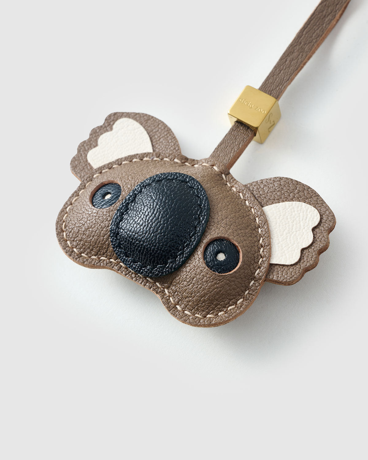 Close-up of the koala charm — hand-cut and hand-stitched panels of French Alran goatskin. Every layer by hand.