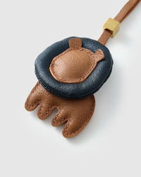 LION CHARM on an 18K gold-plated keychain clip with engraved STICKYZOO disc — clips to keys, bags or backpacks.