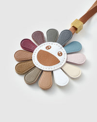 STICKYZOO Night Flower Charm — hand-layered French Alran goatskin, multi-colour petals with smiley face. Designed in Amsterdam.