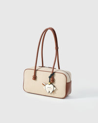 Both editions of the tooth fairy — leather strap loop for bags, or 18K gold-plated keychain clip.
