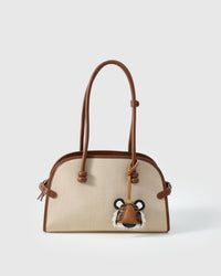 TIGER CHARM charm styled on a bag — a small, specific piece that turns a simple bag into a personal one.