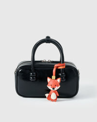 FOX CHARM charm styled on a bag — a small, specific piece that turns a simple bag into a personal one.