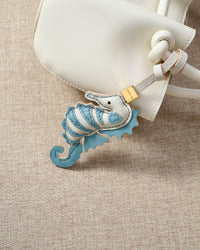 Blue seahorse on an 18K gold-plated keychain clip with engraved STICKYZOO disc — clips to keys, bags or backpacks.