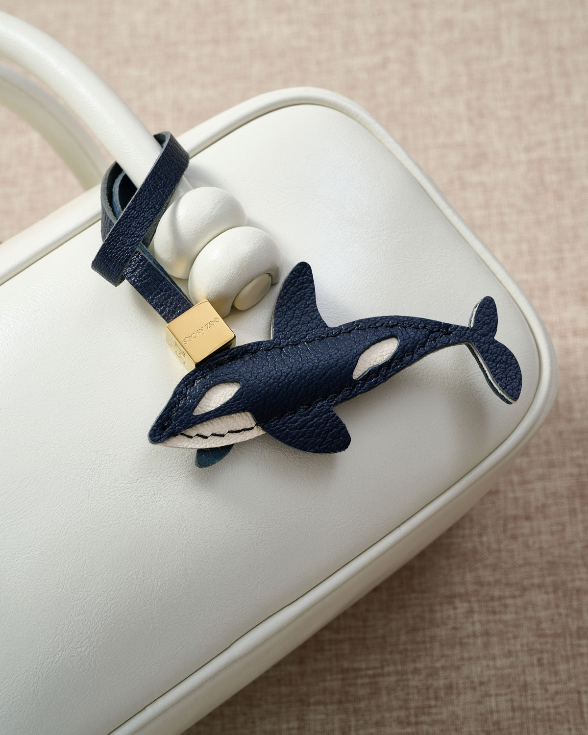 {{Real leather. Not faux.}} Orca charm — genuine French Alran goatskin. Never vegan. Never synthetic.
