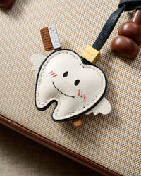 Tooth fairy on an 18K gold-plated keychain clip with engraved STICKYZOO disc — clips to keys, bags or backpacks.