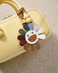 STICKYZOO Night Flower Charm — hand-cut, hand-stitched multi-colour petals with smiley face in French Alran goatskin. Designed in Amsterdam.