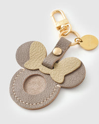 Taupe Mickey AirTag holder — loved by thousands of AirTag owners. Real French leather, 3 days by hand.