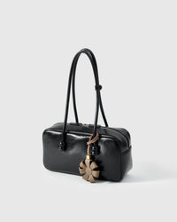 STICKYZOO Daisy Bag Charm with engraved gold hardware cube — handmade French Alran goatskin, warm taupe.