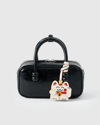Maneki Neko (Lucky Cat) on a bag, side angle — loved by thousands of cat people. Real French leather, 3 days by hand.