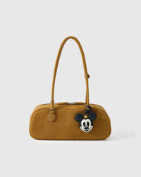Mickey charm on a bag, side angle — loved by thousands of character-charm fans. Real French leather, 3 days by hand.