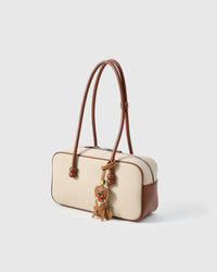 Handmade Golden Retriever leather bag charm styled on a handbag — French Alran goatskin, 18K gold-plated hardware. STICKYZOO.