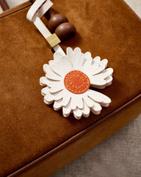 STICKYZOO Daisy Charm — hand-cut, hand-stitched layered daisy petals in French Alran goatskin. Designed in Amsterdam.