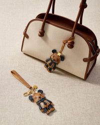 Close-up of the violent bear charm — hand-cut and hand-stitched panels of French Alran goatskin. Every layer by hand.