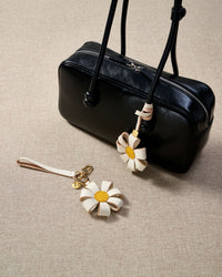Close-up of STICKYZOO Daisy Bag Charm — full-grain French Alran goatskin from Tarn, France. 3d folded daisy petals. 3-day handmade piece.