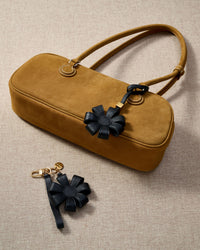 Close-up of STICKYZOO Daisy Bag Charm — full-grain French Alran goatskin from Tarn, France. 3d folded daisy petals. 3-day handmade piece.
