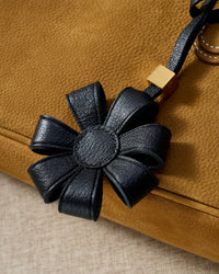 STICKYZOO Daisy Bag Charm — hand-cut, hand-stitched 3D folded daisy petals in French Alran goatskin. Designed in Amsterdam.